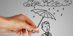 Man standing under the rain and protected with umbrella