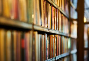 Close-up view of library shelves filled with books, ideal for concepts of education and literature.